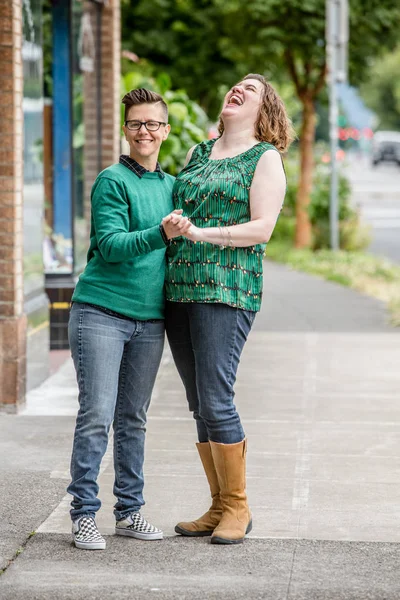 Laughing couple standing outdoors