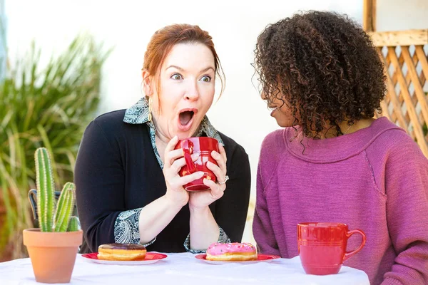 Excited couple at restaurant sharing secrets — Stock Photo, Image