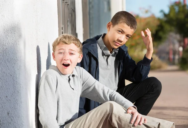 Embarrassed teen with friend reacting shamefully — Stock Photo, Image