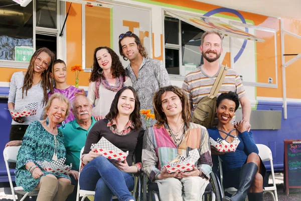 Sorridente diversi amici stand by food truck — Foto Stock