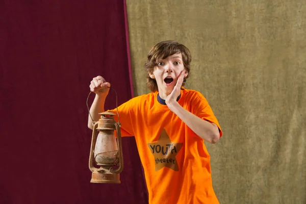 Surprised boy holding lamp — Stock Photo, Image