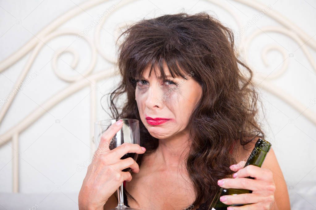 Closeup of Upset Woman Drinking Wine in Bedroom
