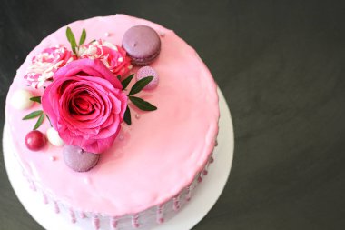 Rose ve macarons tarafından dekore edilmiş lezzetli pembe ev yapımı kek