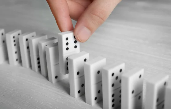 Male hand getting out domino — Stock Photo, Image