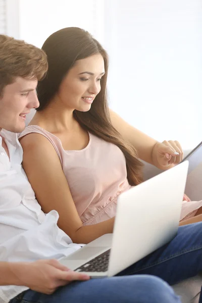 Beautiful couple surfing internet on tablet at home — Stockfoto