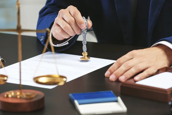 Notary public in office stamping document — Stock Photo, Image