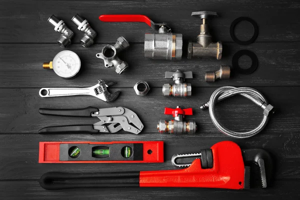 Plumber tools on a gray wooden background — Stock Photo, Image