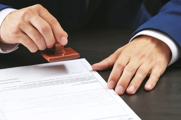 Notary public in office stamping document — Stock Photo, Image