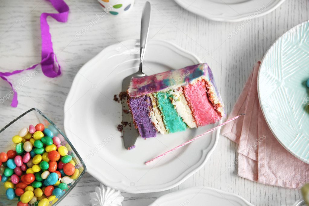 Colorful cake slice on white festive table