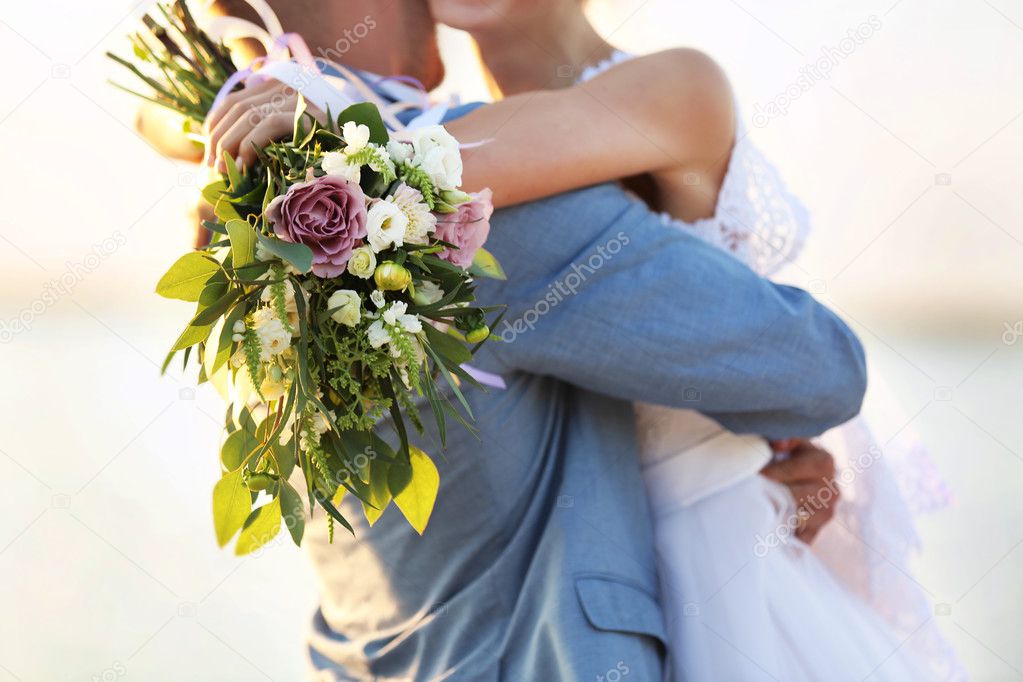 Groom and bride hugging, outdoor