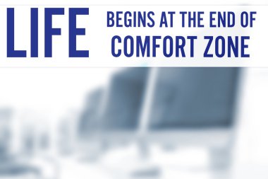 Comfort zone concept. Text on blurred view of modern computers in office