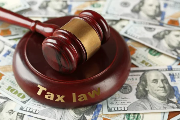 Law gavel on dollars background, closeup. Tax law concept — Stockfoto