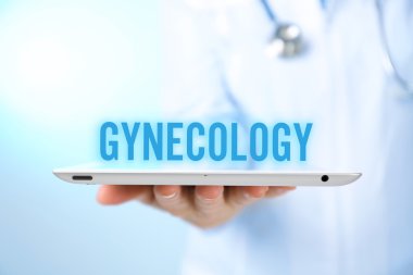 Gynecology concept. Professional doctor with tablet on blue background clipart