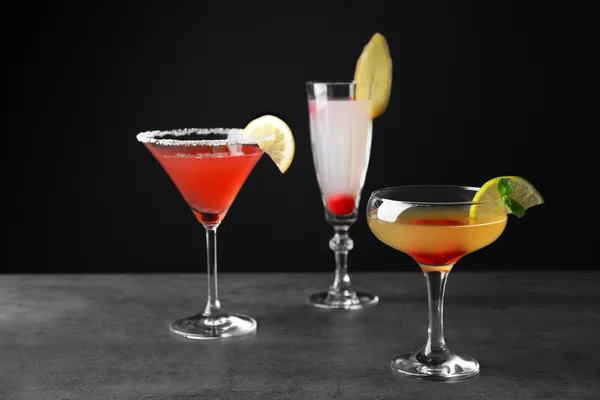 Вкусные коктейли на сером столе — стоковое фото