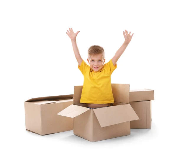 Little boy playing with cardboard boxes isolated on white — Stock Photo, Image
