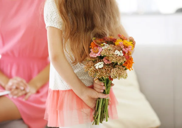 Liten flicka håller bukett blommor — Stockfoto