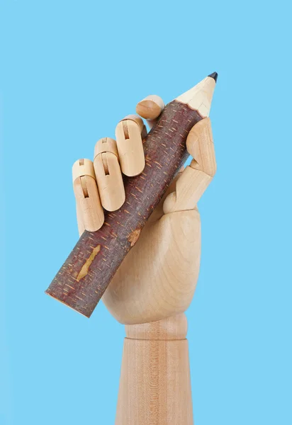 Wooden hand holding big pencil on white background — Stockfoto