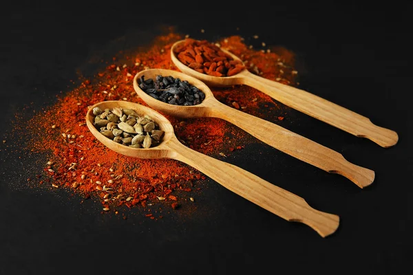 Spices in wooden spoons — Stock Photo, Image