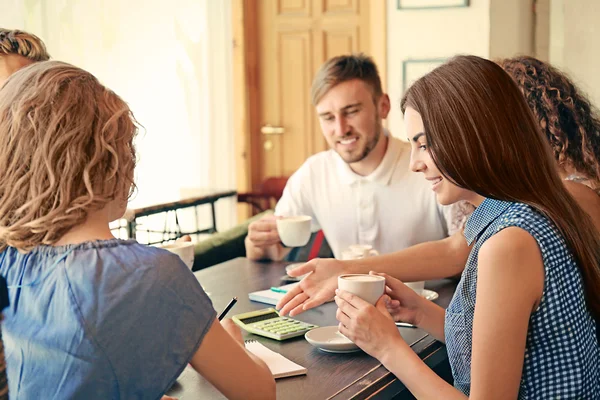 stock image Happy friends drinking coffee in cafe