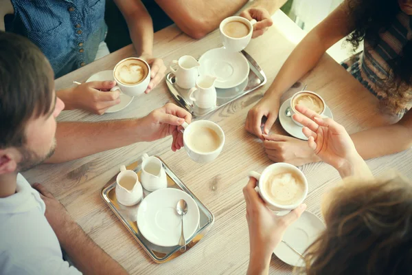 Friends drinking coffee in cafe — Stock Photo, Image