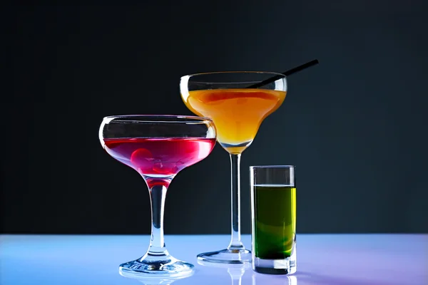 Different drinks on light table — Stock Photo, Image