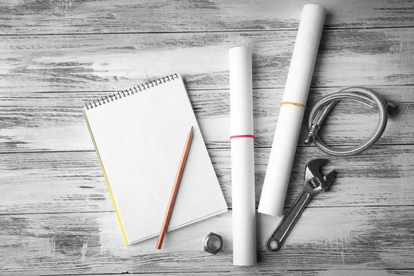 Notebook and plumber tools — Stock Photo, Image