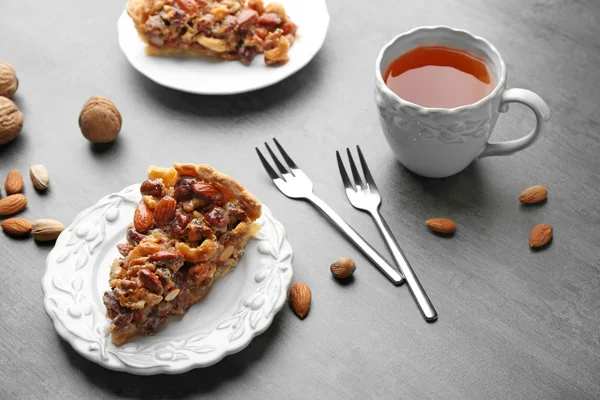 Cup of tea and tasty tart on table — Stock Photo, Image
