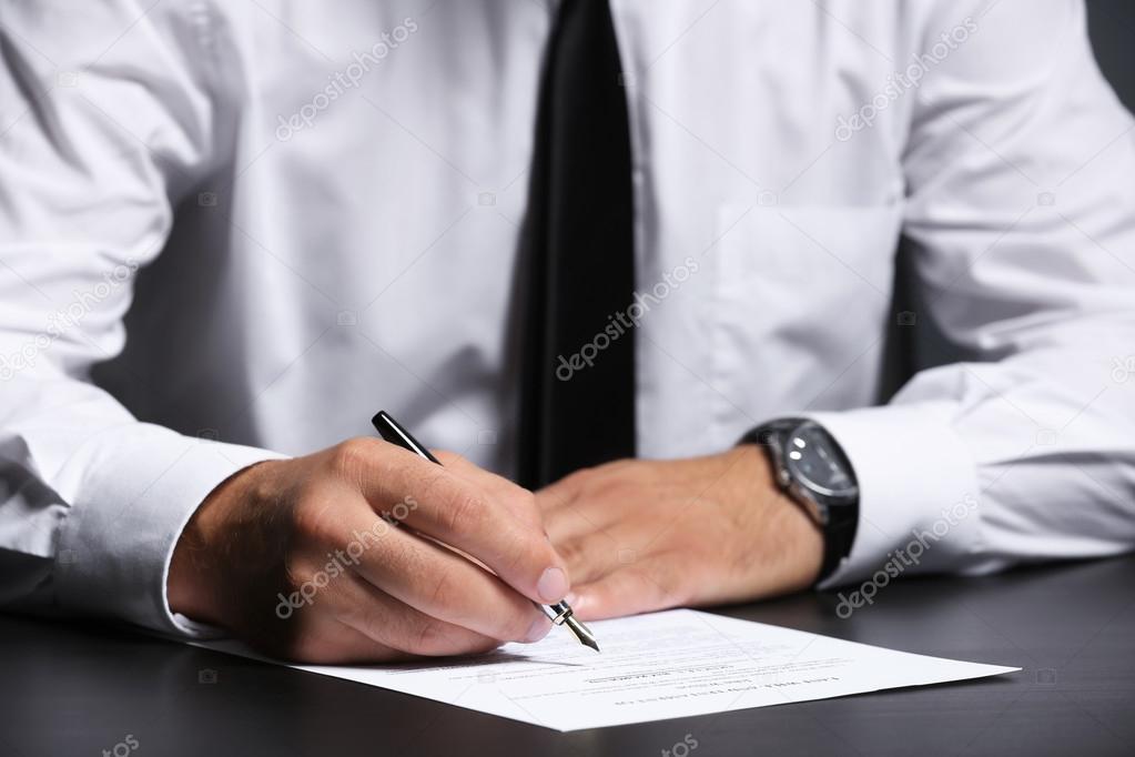 Man signing last will and testament, closeup