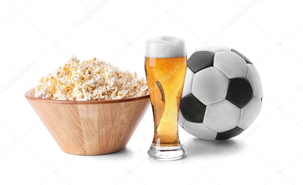 Popcorn, ball and glass of light beer isolated on white
