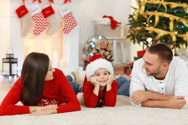 Happy family in living room decorated for Christmas