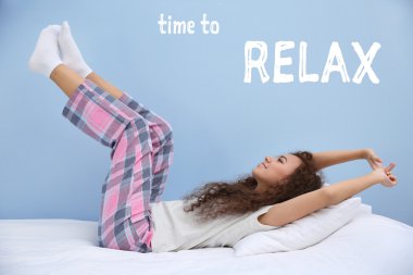 Beautiful young woman stretching after wake up. Text TIME TO RELAX on blue background. clipart