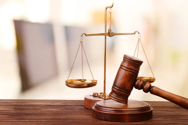Judge's gavel and scales on blurred computers background — Stockfoto