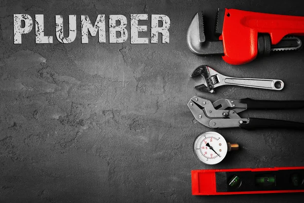 Plumbing concept. Plumber tools on concrete structure background — Φωτογραφία Αρχείου