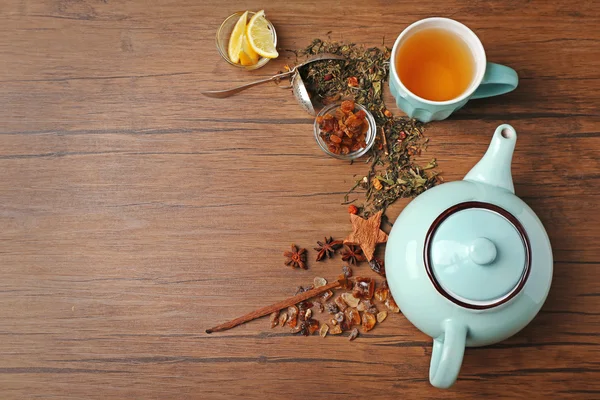 Ingredients for tea drinking on wooden background, flat lay — Stock Photo, Image