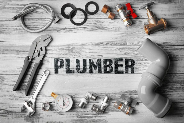 Plumbing concept. Plumber tools frame on wooden structure background — Stock Photo, Image