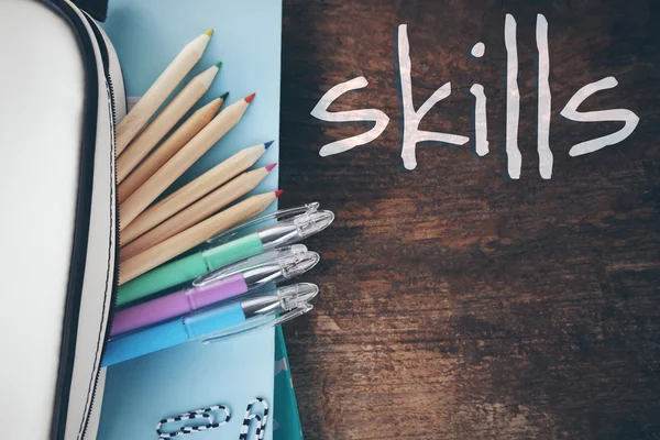 Skills. Pencil case with various stationery on old wooden table — Φωτογραφία Αρχείου