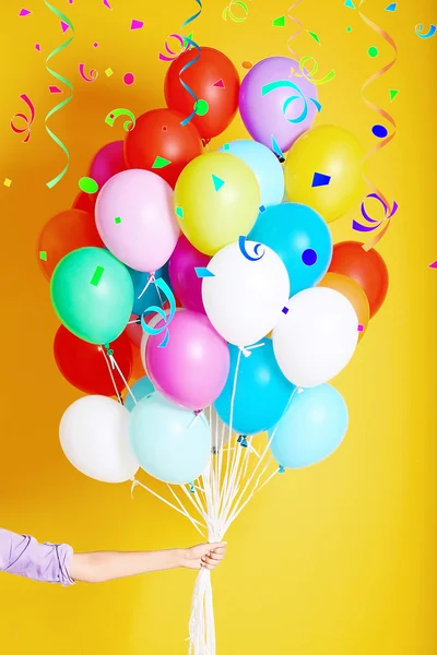 Woman holding many colorful balloons — Stock Photo, Image