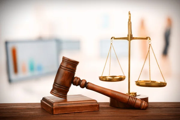 Judge's gavel and scales on blurred computers background — Stock Photo, Image