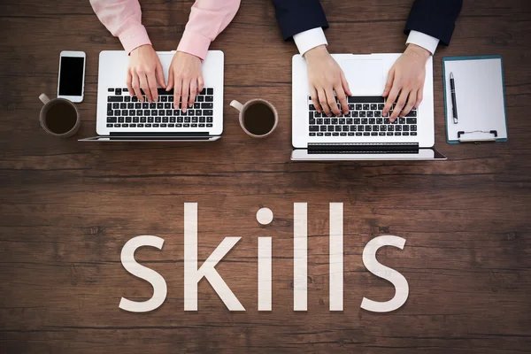 Skills. Man and woman working on laptops — Stockfoto
