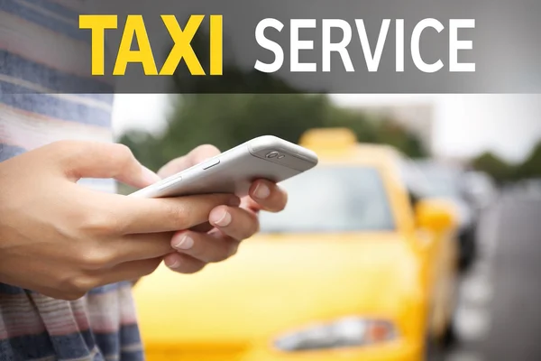 Hand with cellphone calling taxi — Stock Photo, Image