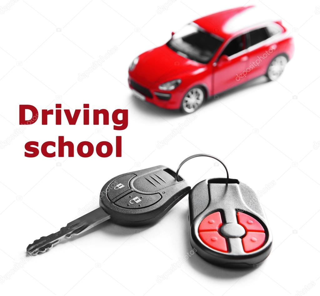 Driving school concept. New red car with keys, isolated on white