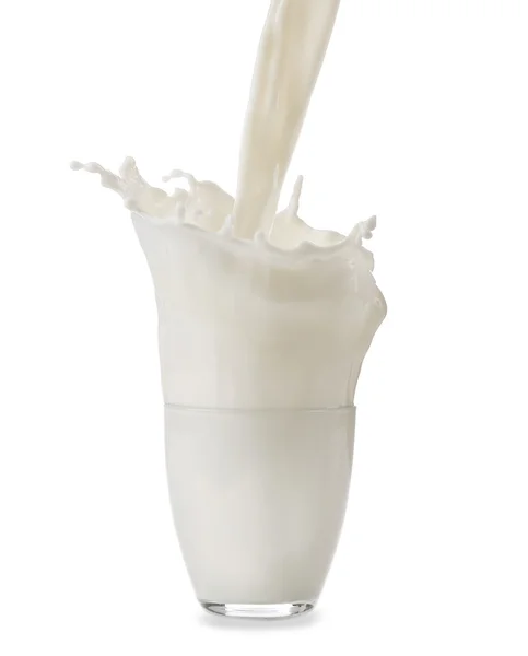 Pouring milk in glass on white background — Stock Photo, Image