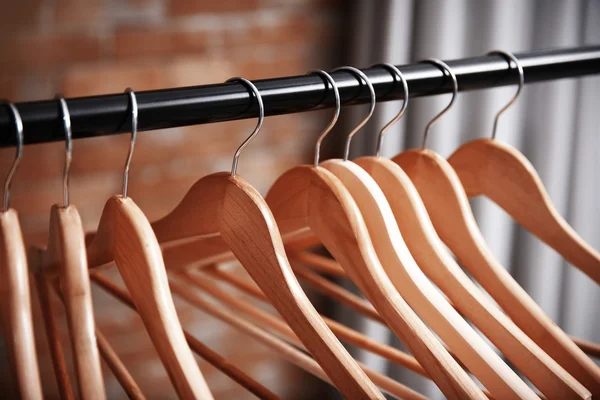 Clothes rail with wooden hangers, closeup — Stock Photo, Image