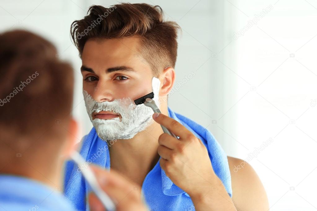Young man shaving 