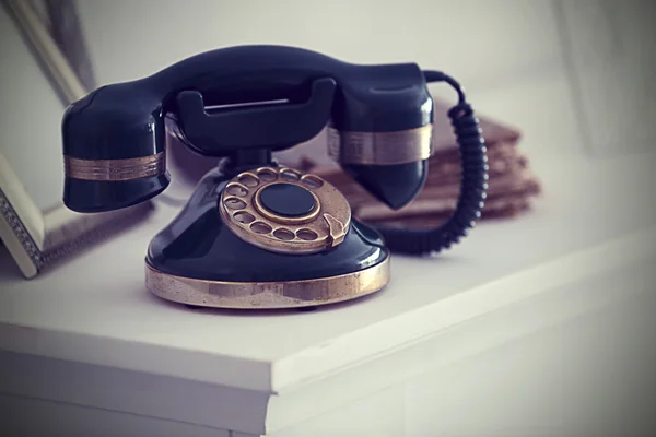 Винтажный телефон на белом камине — стоковое фото