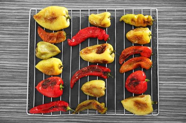 Roasted peppers on grill grid — Stock Photo, Image