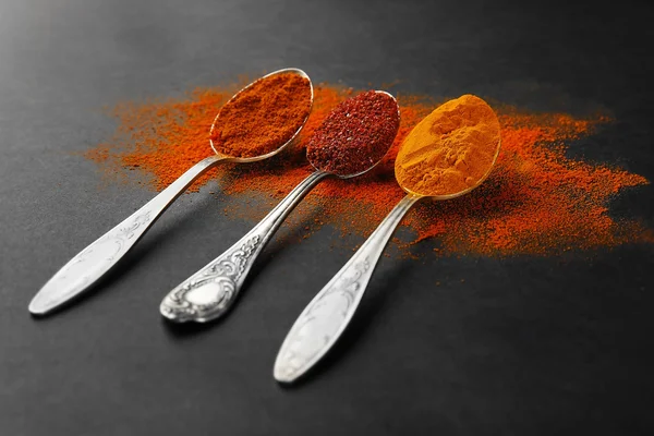 Spices in  spoons on a dark background — Stock Photo, Image