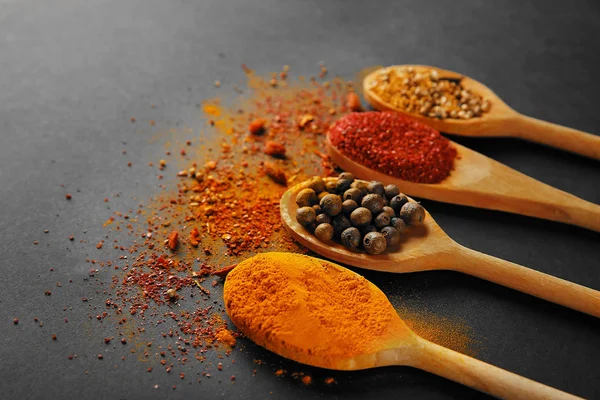 Spices in wooden spoons — Stock Photo, Image