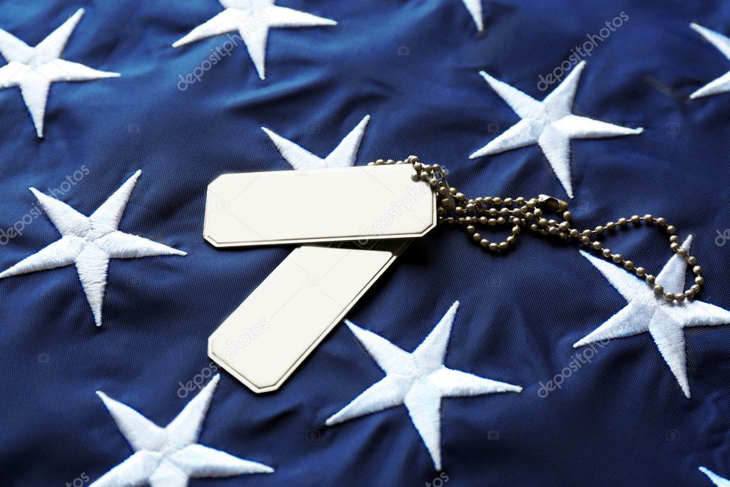Soldier's tokens on American flag background