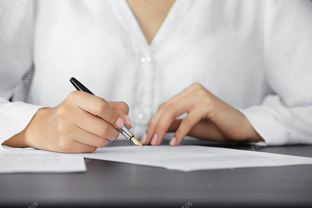 Woman in white skirt signing testament, close-up